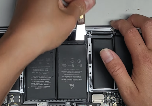 Certified technician repairing MacBook battery at Volta PC Upgrade & Repair Singapore
